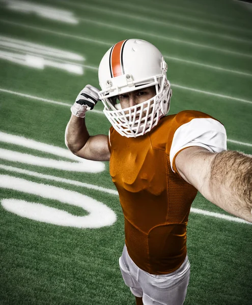 Football Player with a orange uniform — Stock Photo, Image