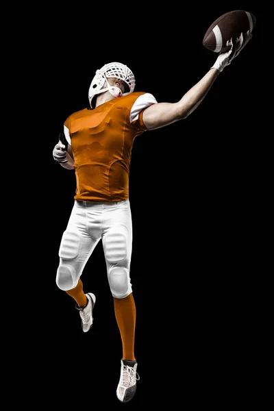 Fotbollsspelare med en orange uniform — Stockfoto