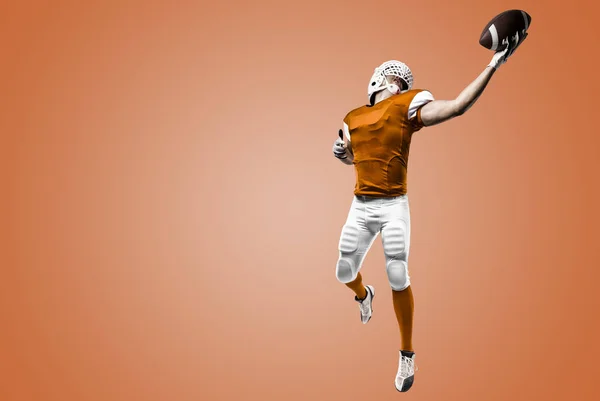 Jogador de futebol com um uniforme laranja — Fotografia de Stock