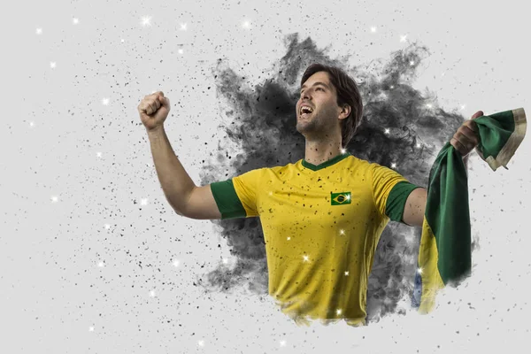 Brazilian soccer player coming out of a blast of smoke — Stock Photo, Image