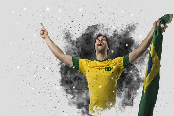 Brazilian soccer player coming out of a blast of smoke — Stock Photo, Image