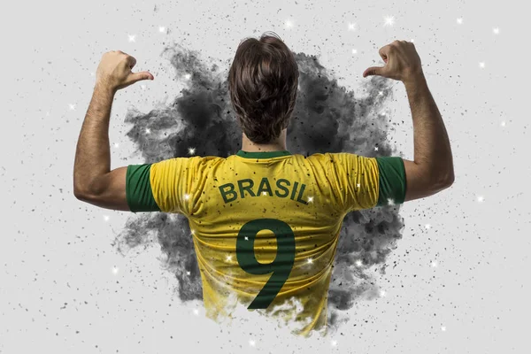 Brazilian soccer player coming out of a blast of smoke — Stock Photo, Image