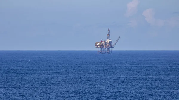 Oil platform inside the sea on a sunny day.