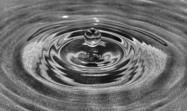 Bir damla su düşüyor ve dalgalanmalar yaratıyor..