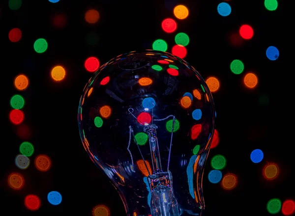 Light bulb on multicolored lights background, I have an idea !!