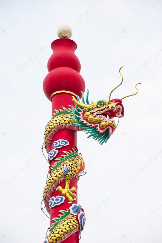 Golden dragon statue on pole in the Chinese temple in Thailand.