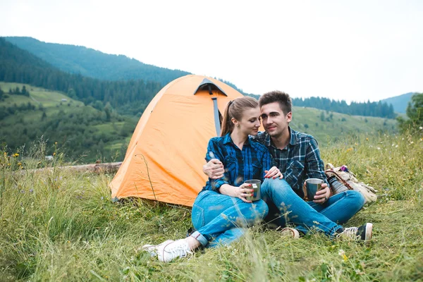 Chico y chica amantes turistas relajarse y admirar hermosos paisajes de montaña — Foto de Stock