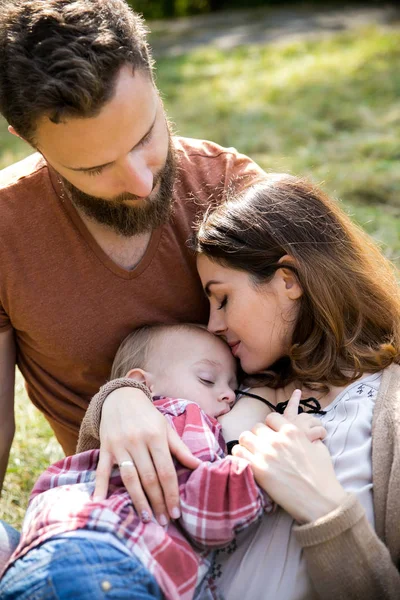 Young beautiful family with a child — Stock Photo, Image
