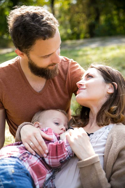 Young beautiful family with a child — Stock Photo, Image