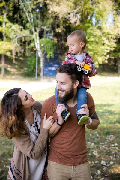 Young beautiful family with a child — Stock Photo, Image