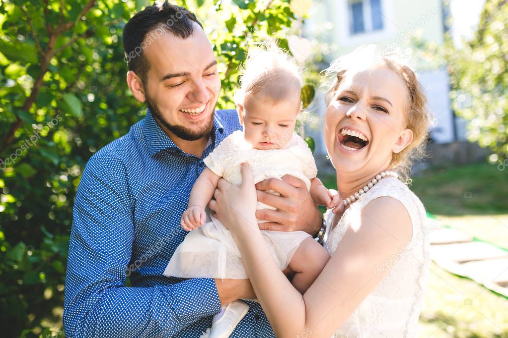 Happy joyful young family with child. Father, mother and little boy having fun