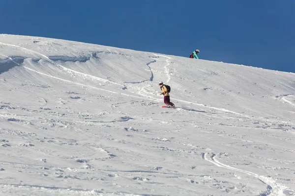 Snowboard mulheres snowboard na neve branca fresca com pista de esqui no dia ensolarado de inverno — Fotografia de Stock