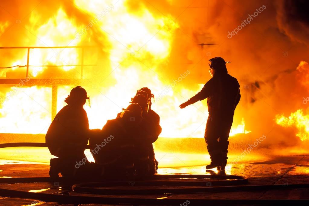 Fire chief giving instructions to firefighters during firefighting exercise