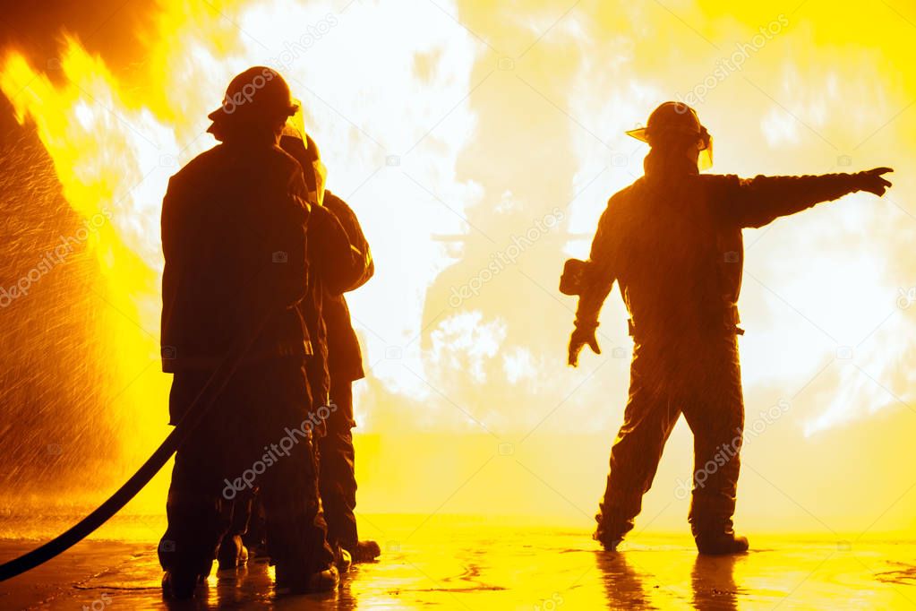 Fire chief pointing to the right during firefighting exercise