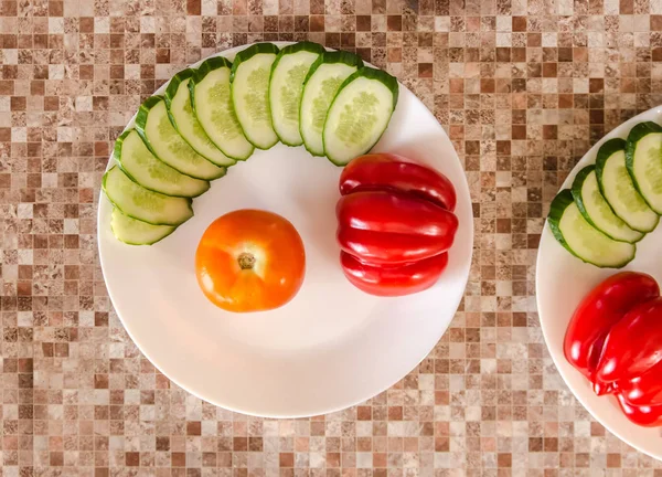 Sliced cucumbers, peppers and tomatoes — Stock Photo, Image