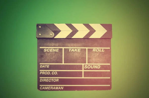 Filming, movie clapperboard on green — Stock Photo, Image