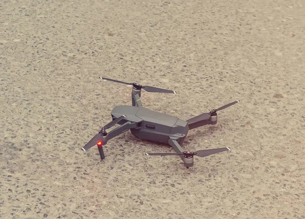 Quadcopter on ground. Summer evening — Stock Photo, Image