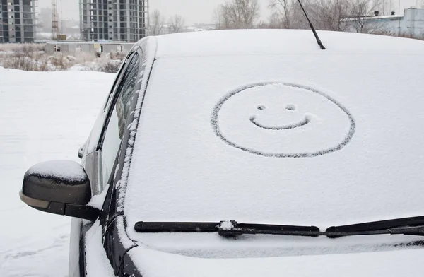 smiling face with snow on car