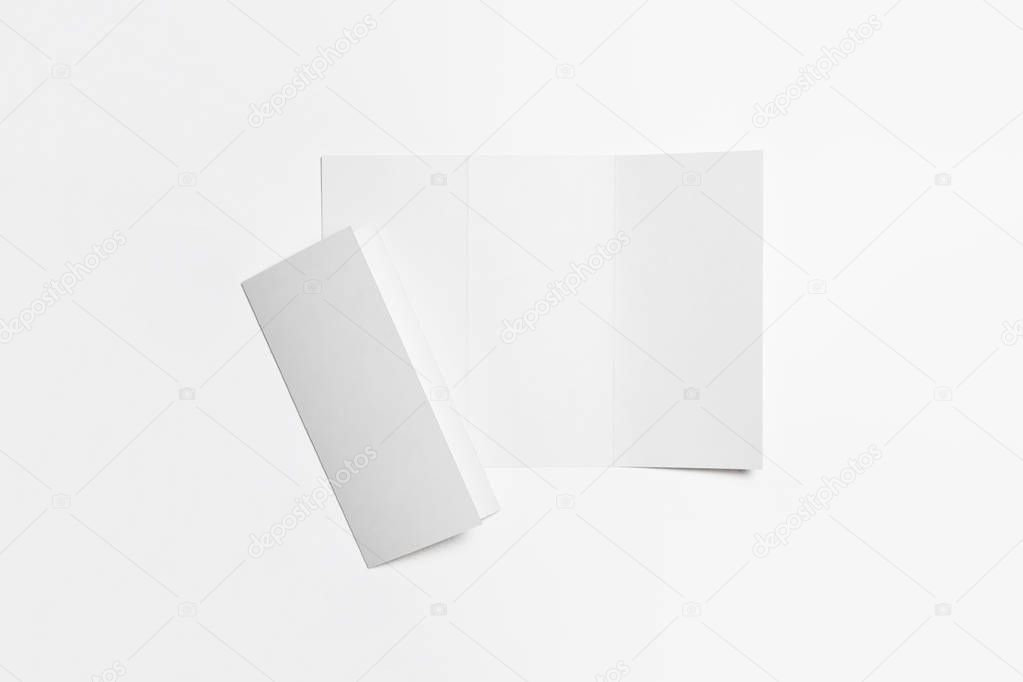 A4. Blank Trifold Paper Brochure Mock-up on soft gray background with shadow. High-resolution photo.Top view