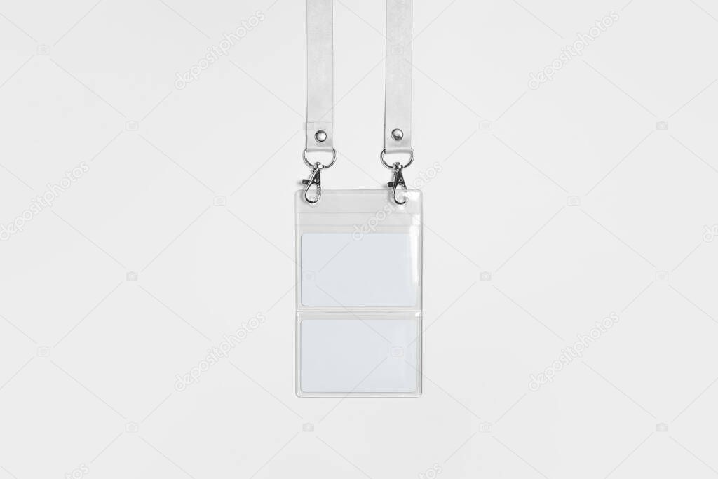 Blank white Badge with Lanyard lace Mock-up.High-resolution photo.Nametag with white ribbon and transparent plastic paper holder. Corporate design.