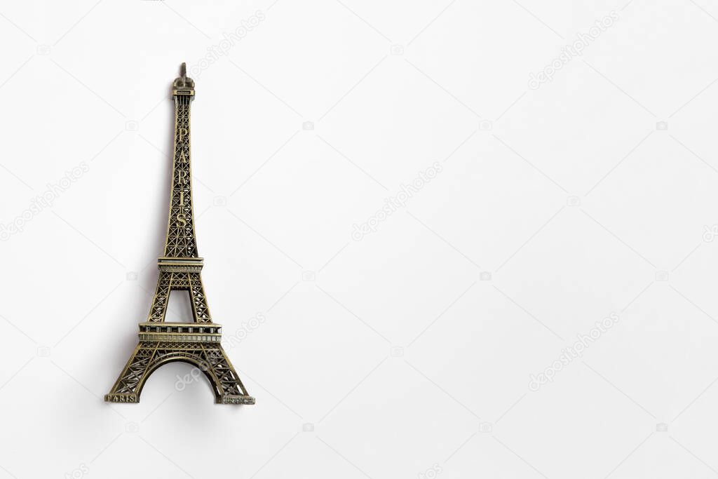 The small Eiffel tower as a souvenir from Paris. Isolated on a white background.