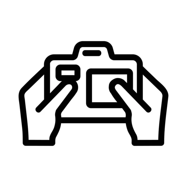 Caméra dans les mains du vecteur icône. Illustration de symbole de contour isolé — Image vectorielle
