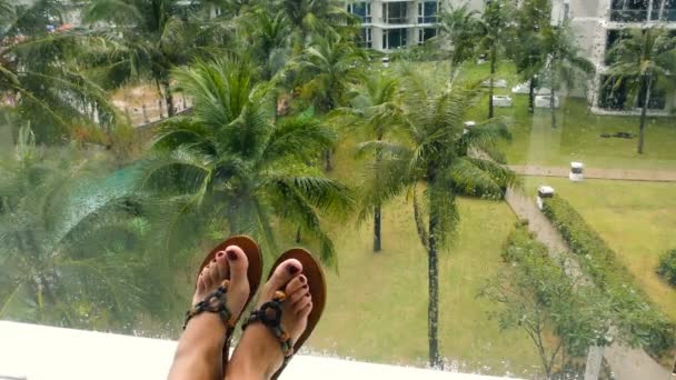 Female feet against tropical scene — Stock Video