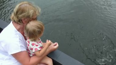 Çocuk balık besleme büyükanne ile