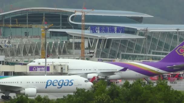 波音 767-3q8 的士在普吉岛国际机场。波音 747 上背景站在码头附近. — 图库视频影像