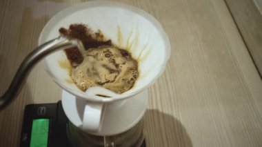 Barista making coffee using a funnel
