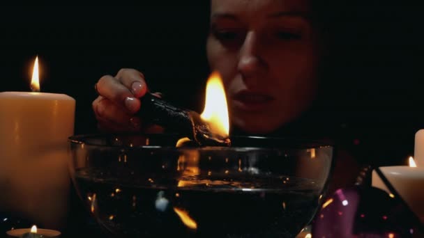 Black ritual with candle — Stock Video