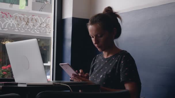 Mujer de negocios utilizar el teléfono inteligente para navegar por Internet en la cafetería — Vídeos de Stock