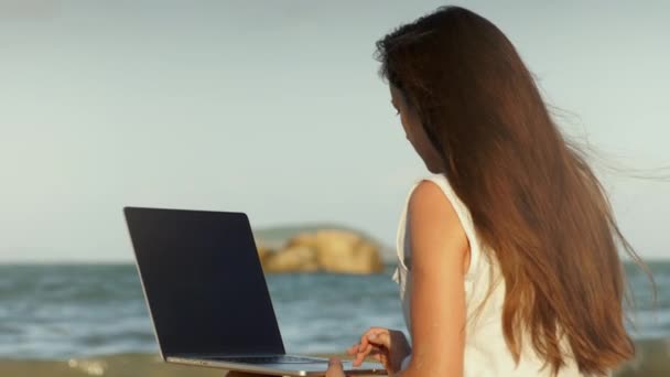 Mulher usando laptop na praia — Vídeo de Stock