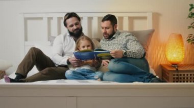 Male Couple with daughter in bedroom