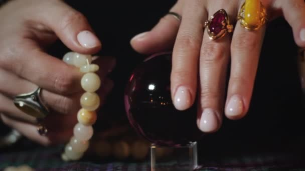 Magician fingers rotate crystal ball — Stock video