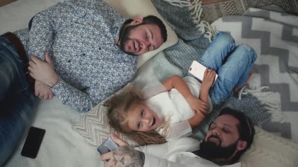 Male Couple Taking Selfies With Little Daughter — Stockvideo