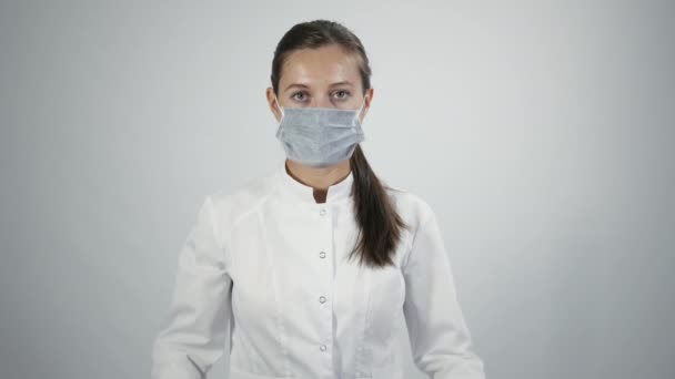 Doctor in medicine mask put on a stethoscope — Stock Video