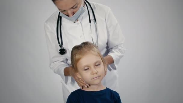 Doctor is palpating lymph node on the neck of 5 years old girl — Stock Video