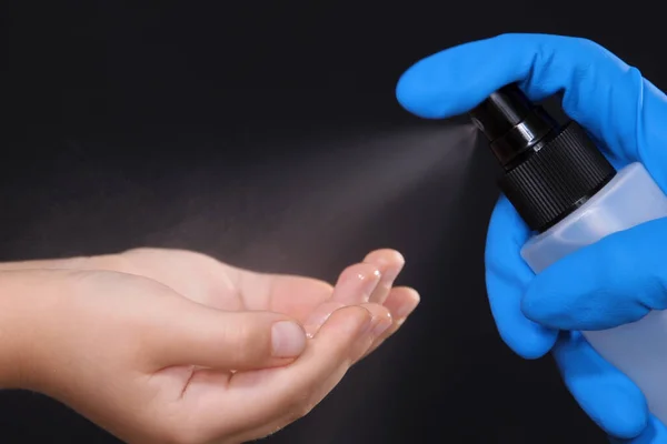 Unrecognizable Person Blue Gloves Applying Sanitizer Spray Child Hands Black Stock Image