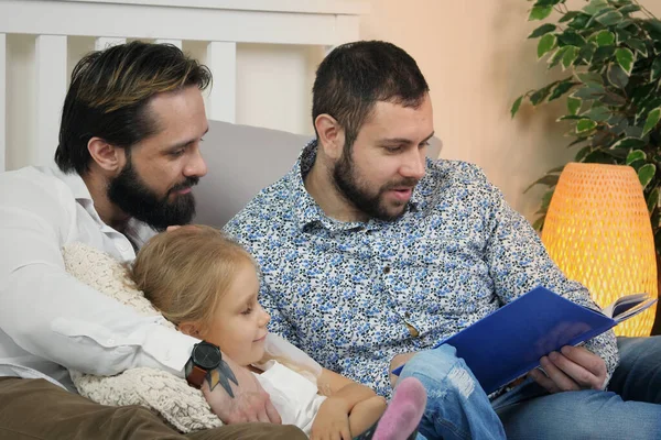 Same Sex Male Couple Home Daughter Homosexual Couple Read Book Stock Photo