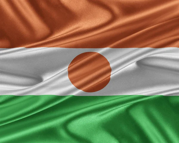 光沢のあるシルクの質感とニジェールの国旗. — ストック写真