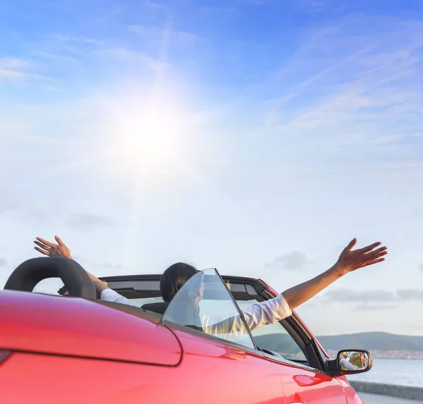 Relaxing woman on the beach in the car.