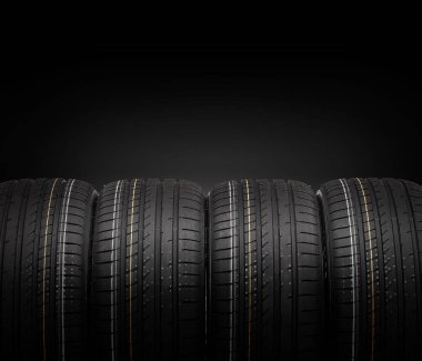 Karanlık bir arka plan üzerinde araba lastikleri.