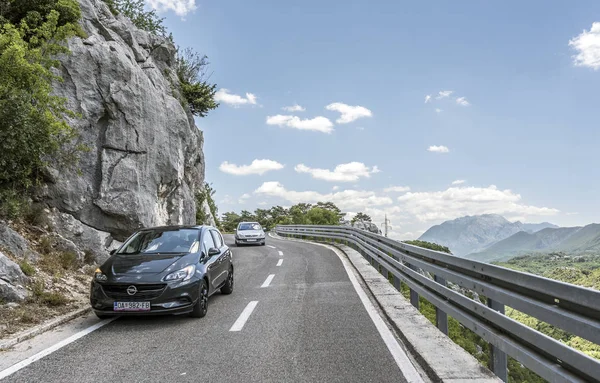 Auto's met moeite die zich uitstrekt over een smalle bergweg. — Stockfoto