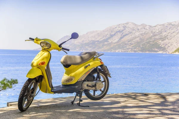 Vélomoteur jaune sans marque sur la plage un jour d'été . — Photo