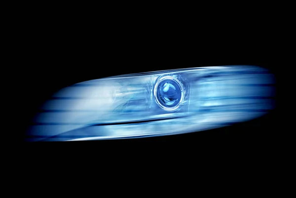 Modern automotive headlight on a black background shine blue light. — Stock Photo, Image
