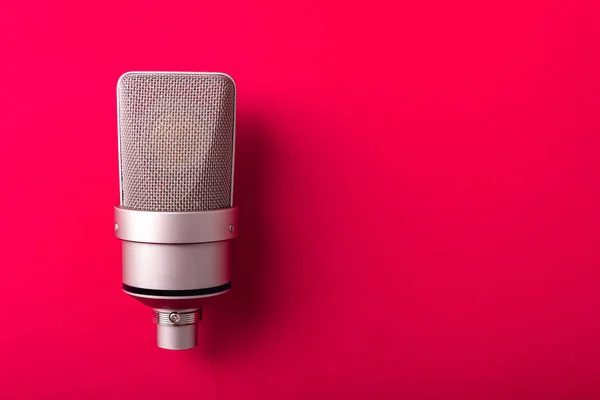 Large diaphragm condenser studio microphone. On red background. — Stock Photo, Image