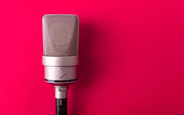 Large diaphragm condenser studio microphone. On red background. — Stock Photo, Image