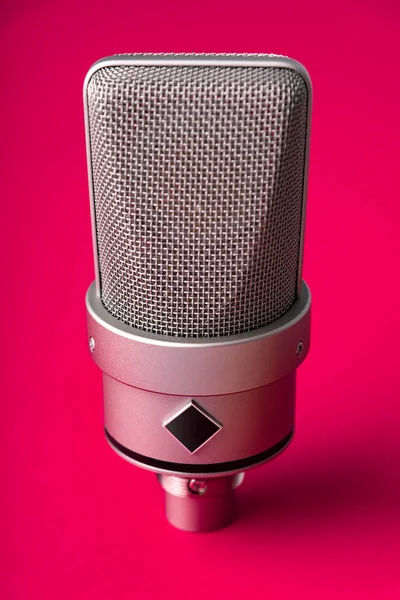 Condensador de diafragma grande microfone estúdio. Em um fundo vermelho . — Fotografia de Stock