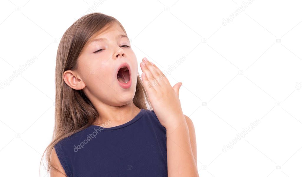 Little girl is yawning. Isolated on a white background.
